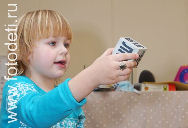 Фотографии детской игры: Фотография девочки с кубиком.