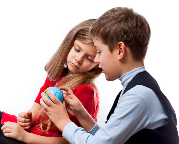 Мальчик показывает девочки маленький глобус. Фотография, ID 17203