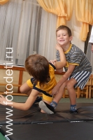 Дети отрабатывают приёмы на тренировке по дзюдо, на фото дети занимаются спортом