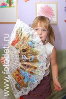 Фото девочки с большим веером, фото сделано на детском празднике
